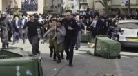 Moment two female Israeli soldiers are rescued as they are chased by 1,000 ultra-Orthodox men
