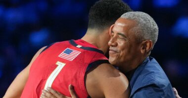 Obama catches loose ball while sitting courtside with Michelle at game