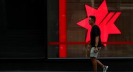 SYDNEY, AUSTRALIA - FEBRUARY 18: A pedestrian moves past a National Australia Bank Ltd. (NAB) central business district branch  on February 18, 2025 in Sydney, Australia. The Reserve Bank of Australia (RBA) is set to announce its monetary policy decision on February 18, 2025, with many experts predicting a rate cut due to easing inflation and economic conditions. This anticipated cut aims to provide relief to mortgage holders and stimulate economic activity amid concerns about weak household con