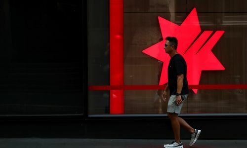 SYDNEY, AUSTRALIA - FEBRUARY 18: A pedestrian moves past a National Australia Bank Ltd. (NAB) central business district branch  on February 18, 2025 in Sydney, Australia. The Reserve Bank of Australia (RBA) is set to announce its monetary policy decision on February 18, 2025, with many experts predicting a rate cut due to easing inflation and economic conditions. This anticipated cut aims to provide relief to mortgage holders and stimulate economic activity amid concerns about weak household con