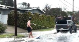 Surfer spotted catching waves on SoCal street during mass flooding