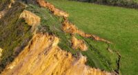 Tonnes of rock slump onto beach weeks after 300ft crack in cliff top