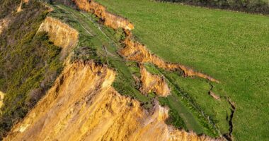 Tonnes of rock slump onto beach weeks after 300ft crack in cliff top