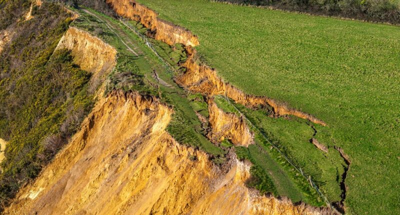 Tonnes of rock slump onto beach weeks after 300ft crack in cliff top