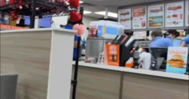 Employee using a trash can to repeatedly fend off an alleged attacker.