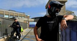 Stage name Sur Ronster an American content creator in his twenties specialising in electric bikes at Observatory Hill near the Sydney Harbour Bridge.