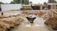 A South African politician goes snorkeling in a giant pothole to highlight city management failures