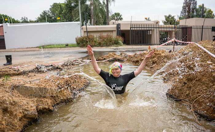 A South African politician goes snorkeling in a giant pothole to highlight city management failures