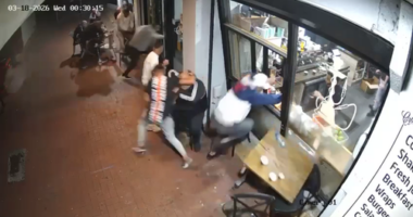 CCTV shows the moments the shots were fired and the men run into the building for cover.