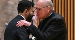 Cardinal Timothy Dolan whispers into Mamdani's ear at NYPD event â as ex-archbishop said he was 'ticked off' at mayoral snubs