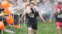 Couples run in the UK wife-carrying race on International Women's Day