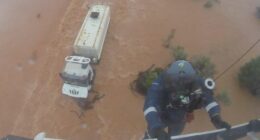 One crew member was winched down, balancing on top of the cabin as the driver clung on.He attached the harness and both were brought to safety