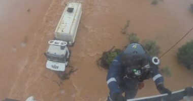 One crew member was winched down, balancing on top of the cabin as the driver clung on.He attached the harness and both were brought to safety