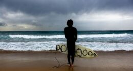 A surfer gauges current conditions at Maroubra beach, ahead of an increased swell in Sydney, Friday, 27 March 2026.