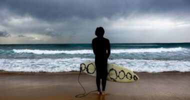 A surfer gauges current conditions at Maroubra beach, ahead of an increased swell in Sydney, Friday, 27 March 2026.