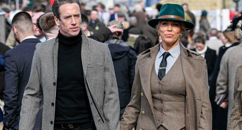 Hannah Waddingham holds hands with spine surgeon at Cheltenham