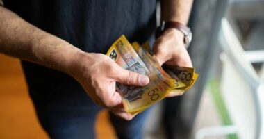 Cash stock image of cash person holding cash Australian money