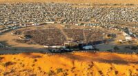 The Big Red Bash, the self-proclaimed world's most remote music ﻿festival, is scrambling to find another venue after a rare deluge hit outback Queensland.