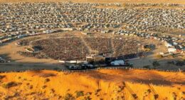 The Big Red Bash, the self-proclaimed world's most remote music ﻿festival, is scrambling to find another venue after a rare deluge hit outback Queensland.