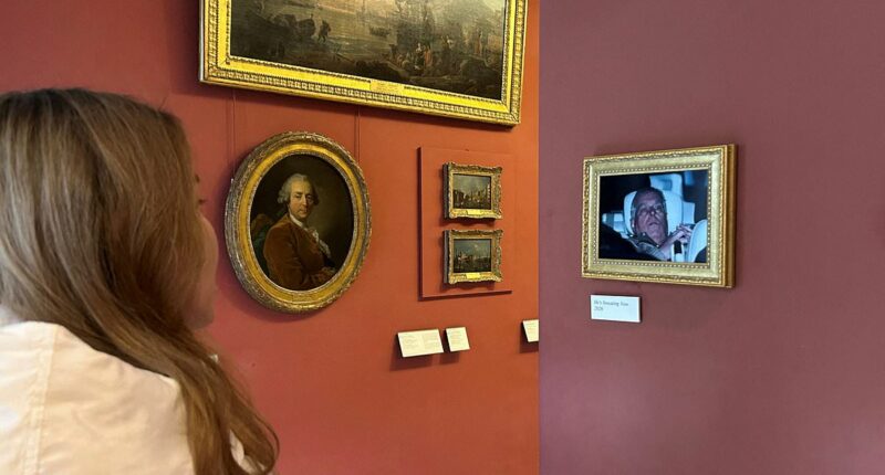 Infamous photo of shamed Andrew being driven from police station after 11 hours in custody is framed and 'put on display at the Louvre'