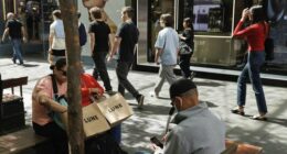 Shoppers sit down for a rest in Pitt St Mall in the Sydney CBD.