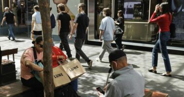 Shoppers sit down for a rest in Pitt St Mall in the Sydney CBD.