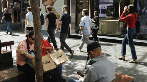 Shoppers sit down for a rest in Pitt St Mall in the Sydney CBD.