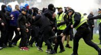 Inside the 'shameful' Old Firm violence: Shocking new footage shows fan being KICKED in the head, a security guard is thrown to the floor and Celtic star clashes with fan as police release statement