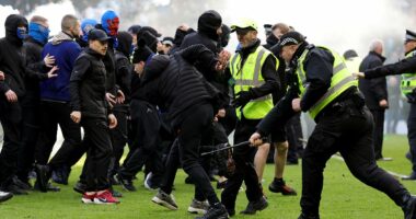 Inside the 'shameful' Old Firm violence: Shocking new footage shows fan being KICKED in the head, a security guard is thrown to the floor and Celtic star clashes with fan as police release statement