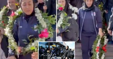 Iranian women's soccer players look terrified as they are greeted back home by officials after being branded 'traitors'