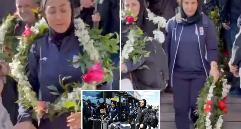 Iranian women's soccer players look terrified as they are greeted back home by officials after being branded 'traitors'