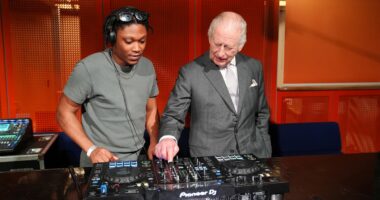 King of the decks! Charles tries his hand at DJing in Manchester - before agreeing 'it's not as easy as it looks'