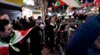 London street brought to a standstill as jubilant people blare music, hand out roses, and wave Iranian flags to celebrate the death of Ayatollah Ali Khamenei