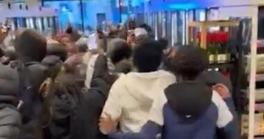 Mob of youths run riot in M&S store as police watch on powerless