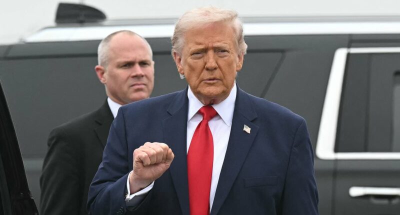 President Donald Trump salutes coffins of six fallen soldiers killed