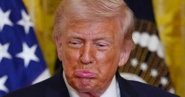 President Donald Trump reacts after Olympic bobsledder Kaillie Humphries presented him with the Order of Ikkos medal at a women's history month event in the East Room at the White House, Thursday, March 12, 2026, in Washington.