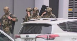 Heavily-armed police in camoflage gear attended the scene.