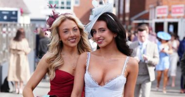 Aintree racegoers don flamboyant hats and mini dresses for Ladies Day
