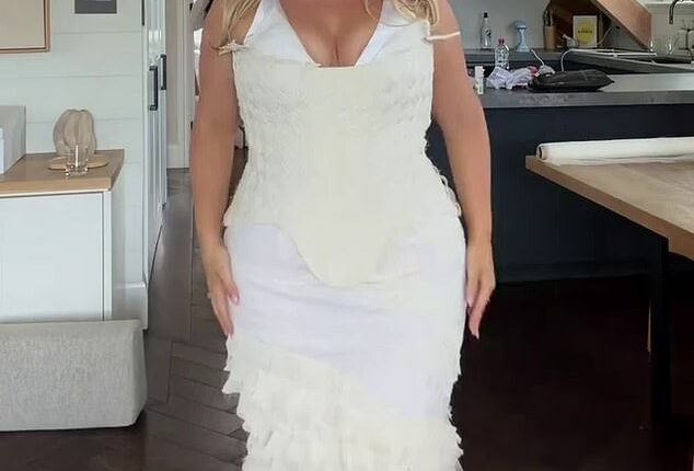 A plus-size model has left her fans divided after she unveiled the white gown she wore for her wedding welcome party