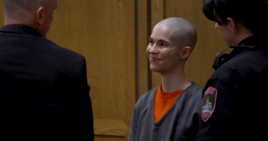 Bald-headed killer smiles as prosecutors reveal what she did before dad walked in