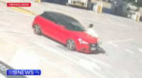 Car swerves along road, trying to shake off woman clinging onto bonnet