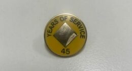 A man claims his mother was given this pin and flowers for 45 years of service at Commonwealth Bank.