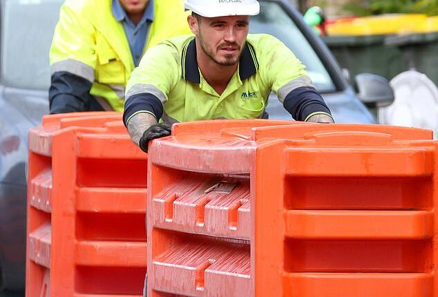 The Budget is setting aside $90.6million to boost the number of skilled workers in the construction sector (pictured are construction workers at Parramatta in Sydney's west)
