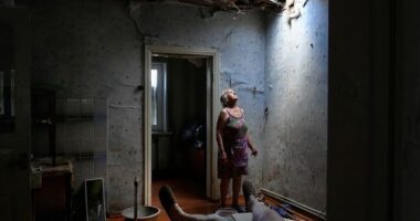 Zoya Shaposhnik 67 (left) looks up at the hole in her ceiling which was damaged this morning at approximately 9am in a missle strike where her ill husband (left) was sitting in their home in Krasnohorivka. Their roof and other parts of their home has been destroyed and Zoya has spent the day removing debris. Krasnohorivka, Ukraine. 16th June, 2022.