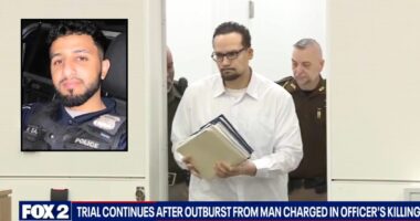 Man accused of killing cop barred from court after outburst