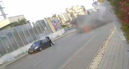 Moment Iran missile lands yards away from Israeli woman, who is knocked to the floor but miraculously manages to walk away