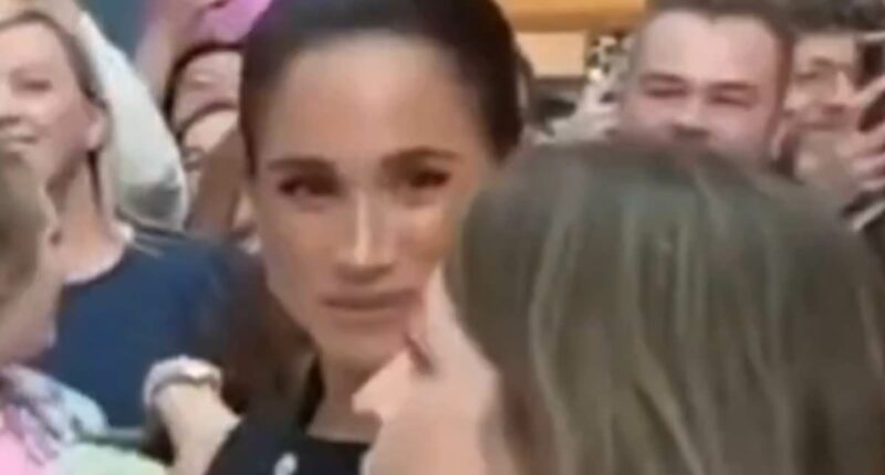 Moment Meghan Markle appears to GLARE at an adviser