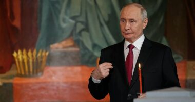 Moment Putin strolls into Easter Sunday service in Moscow - as Elon Musk's father watches on - after 'breaking Kremlin-declared ceasefire'