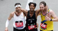 Moment two Boston Marathon runners stop to help exhausted rival finish