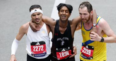 Moment two Boston Marathon runners stop to help exhausted rival finish